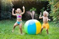 Kids playing with water ball toy sprinkler Royalty Free Stock Photo