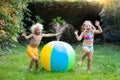 Kids playing with water ball toy sprinkler Royalty Free Stock Photo