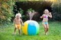 Kids playing with water ball toy sprinkler Royalty Free Stock Photo