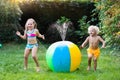 Kids playing with water ball toy sprinkler Royalty Free Stock Photo