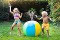 Kids playing with water ball toy sprinkler Royalty Free Stock Photo