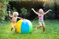 Kids playing with water ball toy sprinkler Royalty Free Stock Photo