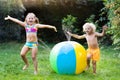 Kids playing with water ball toy sprinkler Royalty Free Stock Photo
