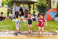 Kids playing with water near their families in a picnic area