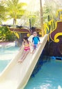 Kids playing on a water slide at a waterpark Royalty Free Stock Photo