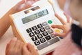 Kids are playing a wooden toy cash register by pressing the number seven, and others on it, respectively Royalty Free Stock Photo