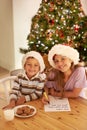 Kids, portrait and christmas cookies note for festive celebration with young siblings in home. Happy, children and Royalty Free Stock Photo