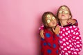 Kids pose on pink background sending kisses, copy space