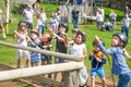 Kids practicing with the catapult in the Norman village. Reconstruction of medieval period 1050, educational centre for kids with