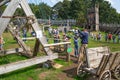 Kids practicing with the catapult in the Norman village. Reconstruction of medieval period 1050, educational centre for kids with