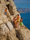 Children climbing up for a cliff dive Royalty Free Stock Photo