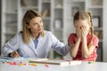 Kids Psychological Problems. Upset little girl crying during therapy session with psychologist Royalty Free Stock Photo