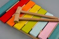 The xylophone and two mallets on the gray background