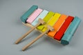 The xylophone and two mallets on the gray background
