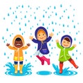 Kids in raincoats and rubber boots playing Royalty Free Stock Photo