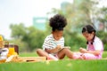 Kids reading a book in summer garden. Children study. Boy and girl play in school yard. Preschool friends playing and learning. Royalty Free Stock Photo