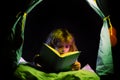 Kids reading books. Dreaming child in kids tent read bedtime stories, fairystory or fairytale.