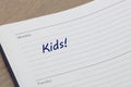 Kids reminder note in blue ink in a diary page
