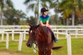 Kids ride horse. Child on pony. Horseback riding Royalty Free Stock Photo