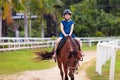 Kids ride horse. Child on pony. Horseback riding Royalty Free Stock Photo