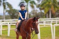 Kids ride horse. Child on pony. Horseback riding