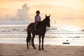 Kids riding horse on beach. Children ride horses Royalty Free Stock Photo