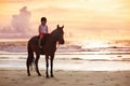 Kids riding horse on beach. Children ride horses