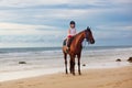 Kids riding horse on beach. Children ride horses Royalty Free Stock Photo