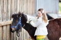 Kids riding pony. Child on horse in Alps mountains