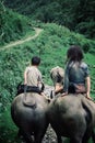 Kids riding water buffaloes in the mountains