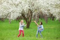 Kids rock band of two happy little girls with vintage guitar and hairbrush as microphone playing music and singing song in spring Royalty Free Stock Photo