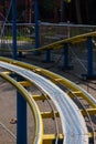 Kids roller coaster yellow rails in amusement park. Royalty Free Stock Photo