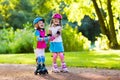 Kids roller skating in summer park Royalty Free Stock Photo