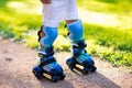 Kids roller skating in summer park Royalty Free Stock Photo