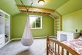 Kids room in bright green with hanging chair Royalty Free Stock Photo