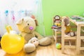 Kids Room Interior with Wooden Furniture Set. Teddy Bear on Chair Big Plush Toys Books Crayons on Table. Royalty Free Stock Photo