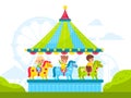 Kids on round carousel with horses. Children ride merry-go-round in amusement park, old roundabout with ponies, carnival