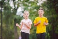 Kids run. Healthy sport. Child sport, heterosexual twins running on track, fitness. Joint training. Running training outdoor Royalty Free Stock Photo