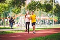 Kids run. Healthy sport. Child sport, heterosexual twins running on track, fitness. Joint training. Running training outdoor Royalty Free Stock Photo