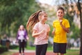 Kids run. Healthy sport. Child sport, heterosexual twins running on track, fitness. Joint training. Running training outdoor Royalty Free Stock Photo