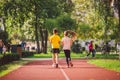 Kids run. Healthy sport. Child sport, heterosexual twins running on track, fitness. Joint training. Running training outdoor Royalty Free Stock Photo