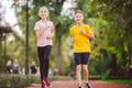 Kids run. Healthy sport. Child sport, heterosexual twins running on track, fitness. Joint training. Running training outdoor Royalty Free Stock Photo