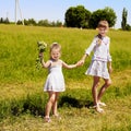 Kids running across green grass outdoor. Royalty Free Stock Photo