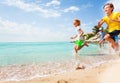 Kids running on the beach water with splashes Royalty Free Stock Photo