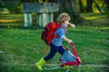 Kids running on green field countryside at green background Little child boy with hikers backpack travelling on Camp Royalty Free Stock Photo