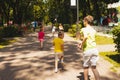 The kids are running on the path in the summer park Royalty Free Stock Photo