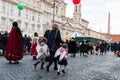 Kids running in street with angel dress in rome