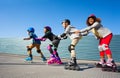 Kids in safety helmets rollerblading on the track Royalty Free Stock Photo