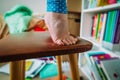 Kids safety- little girl climb on chair at home