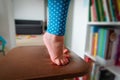 Kids safety- little girl climb on chair at home